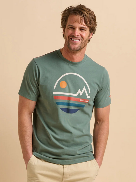 Man wearing a green t-shirt with a graphic design on a beige background