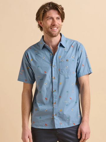 Man wearing a blue patterned shirt against a beige background