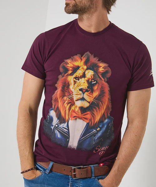 Man wearing a maroon t-shirt with a lion graphic design on a plain background